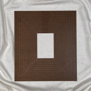 May include: A set of 10 brown paper frames with different sizes, ranging from 6 inches by 4 inches to 16 inches by 14 inches. The frames are arranged in a nested pattern, with the smallest frame in the center and the largest frame on the outside.