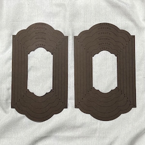 May include: Two sets of brown cardstock frames with scalloped edges. Each set has six frames with different sizes, ranging from 8 inches by 4 inches to 15 inches by 8 inches. The sizes are printed on each frame.