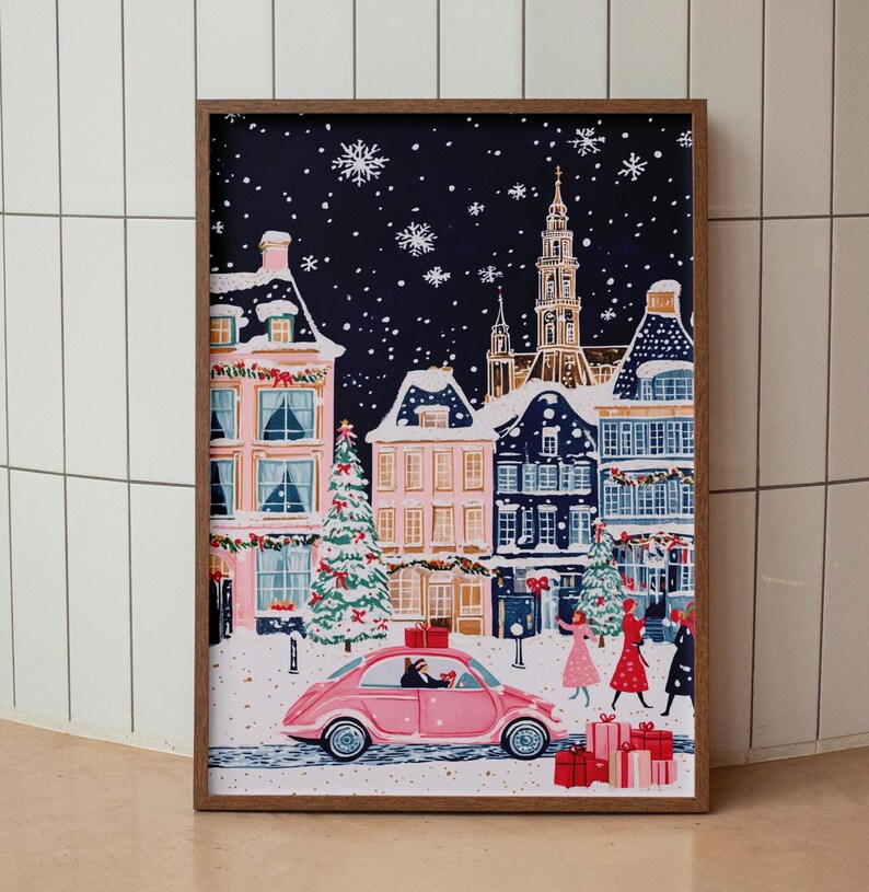 May include: A pink car drives through a snowy, nighttime town scene. The car is decorated with a red bow and has a dog in the passenger seat. The town is decorated with Christmas lights and snow is falling.