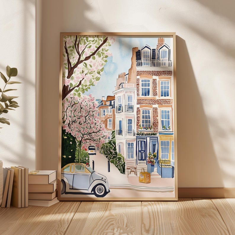 May include: A watercolor painting of a street scene in London, England. The painting features a row of brick buildings with colorful doors and windows. There is a small blue car parked in front of the buildings, and a tree with pink blossoms in the foreground.