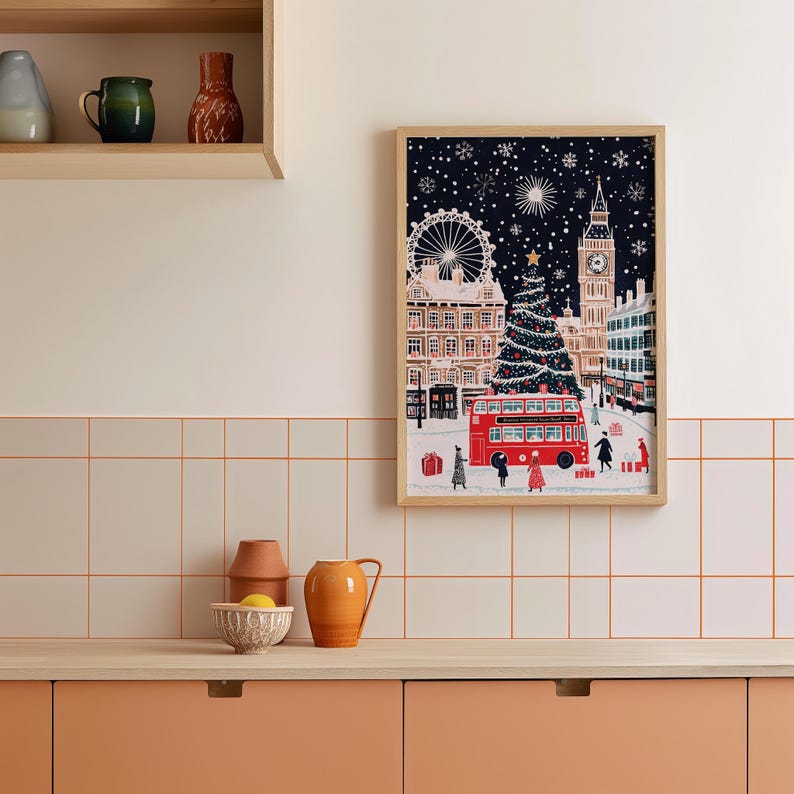 May include: A framed illustration of a snowy London street scene with a red double-decker bus, a Christmas tree, and Big Ben in the background.