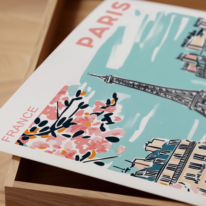 May include: A white and blue illustration of the Eiffel Tower in Paris, France. The illustration includes pink cherry blossoms and the text "PARIS" and "FRANCE".