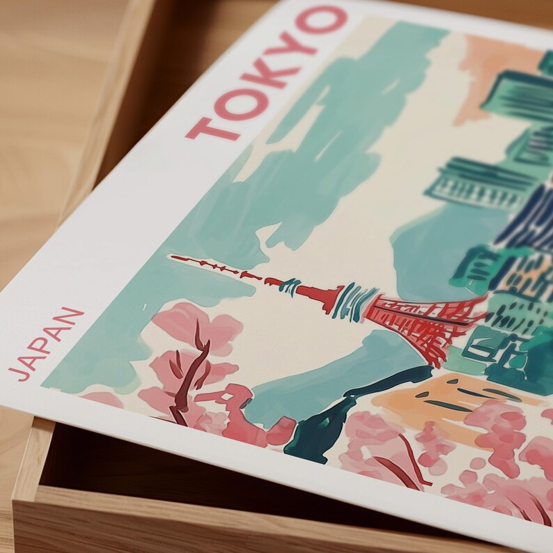 May include: A white poster with the words "TOKYO" and "JAPAN" in pink lettering. The poster features a watercolor illustration of the Tokyo Skytree, cherry blossoms, and a cityscape in the background.