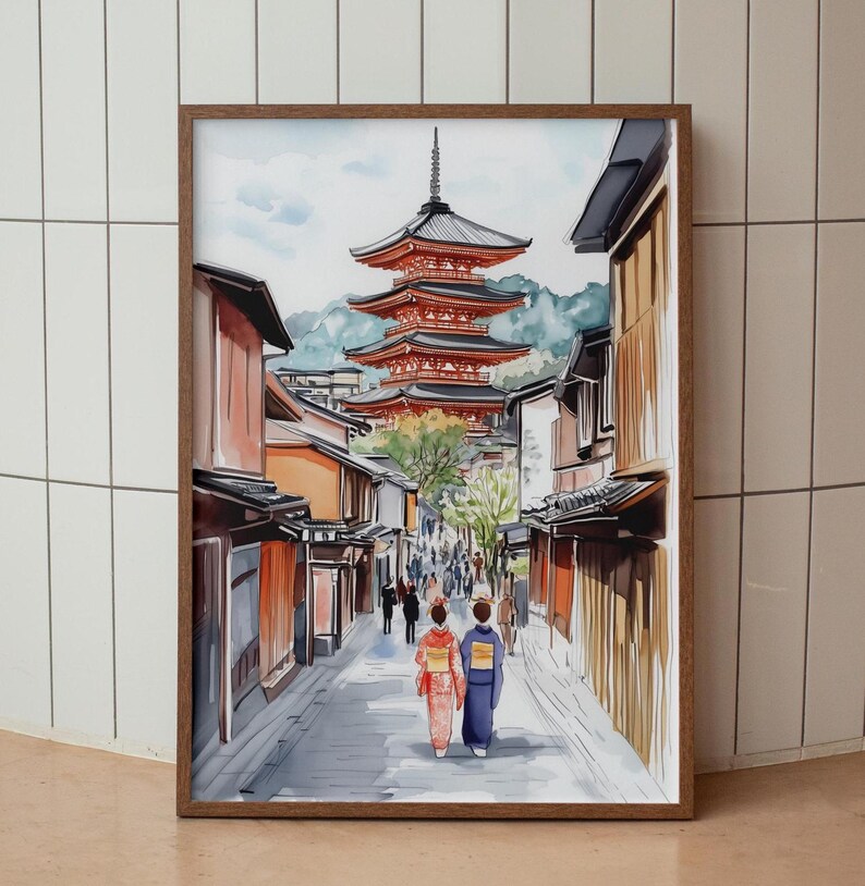 May include: Watercolor print of a Japanese street scene with a red pagoda in the background. Two figures in traditional clothing walk down a cobblestone street lined with buildings. The artwork is framed in a brown wooden frame.