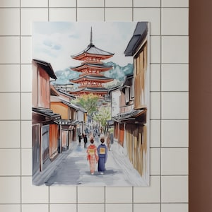 May include: Watercolor painting of a Japanese street scene. A multi-tiered red pagoda stands in the background, with buildings lining a cobblestone street. Two figures in traditional dress walk towards the viewer. The artwork is framed and mounted on a white tiled wall.