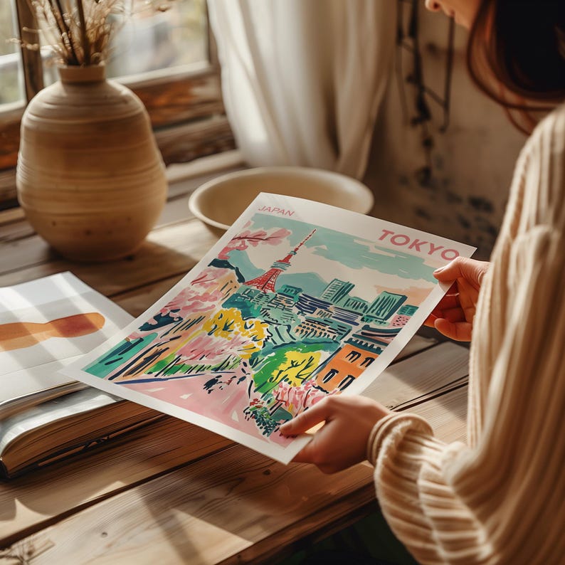 May include: A colorful illustration of Tokyo, Japan, with the Tokyo Tower in the center. The illustration is on a white background with the words "JAPAN" and "TOKYO" in pink.