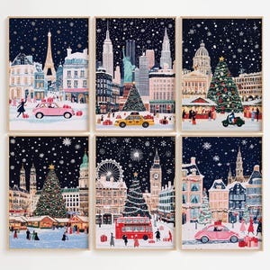 May include: Six framed art prints featuring winter city scenes with Christmas trees, cars, and falling snow. The prints depict landmarks like the Eiffel Tower, Statue of Liberty, and Big Ben, with a festive holiday theme.