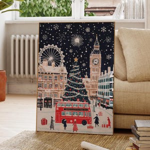 May include: A festive illustration of a snowy London cityscape at night with Big Ben, the London Eye, and a red double-decker bus. A large Christmas tree stands in the center of the scene, decorated with ornaments and lights. The illustration is framed in a gold frame.