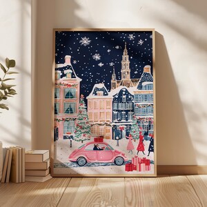 May include: A pink car drives through a snowy European town square at night. The car is decorated with a red bow and a Christmas tree. The buildings are decorated with lights and garlands. The sky is dark blue with white snowflakes.