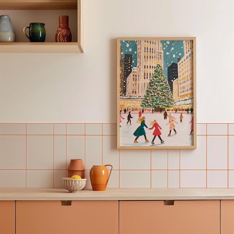 May include: A framed illustration of a snowy city scene with a large Christmas tree in the center. People are ice skating on a rink in front of the tree. The illustration is in a light blue, green, and red color palette.