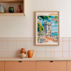 May include: A framed print of a colorful illustration of a tower in Lisbon, Portugal. The print has the text "PORTUGAL" and "LISBON" at the top.