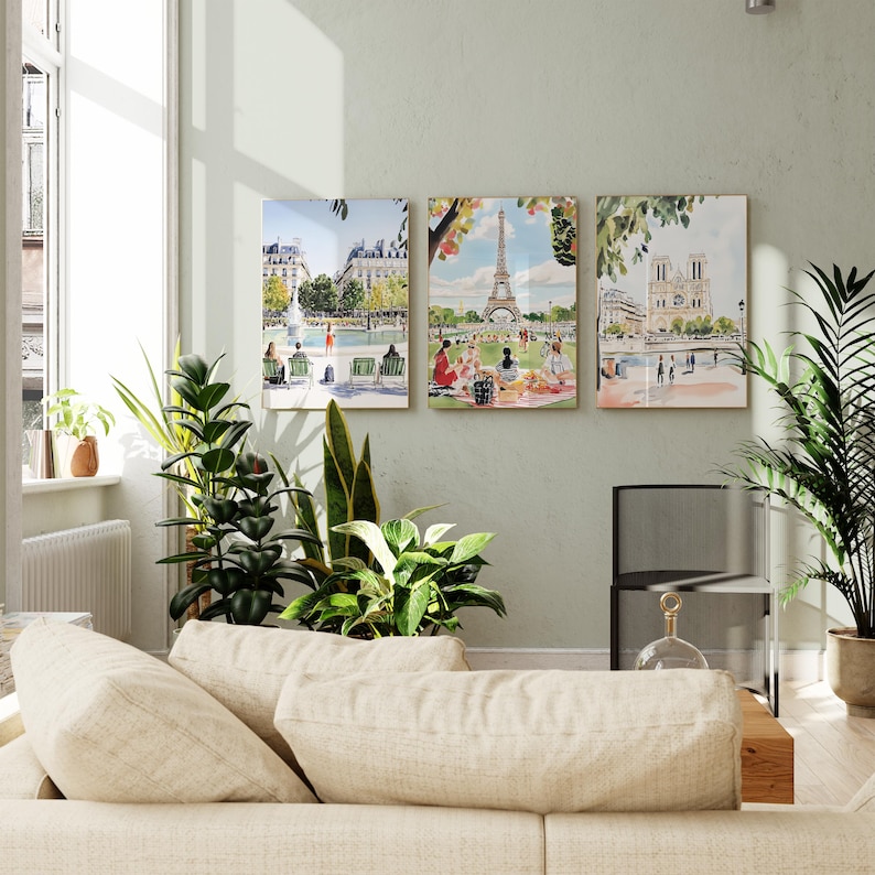 May include: Three watercolor paintings of Parisian landmarks. The first painting shows a fountain in a park with people sitting on benches. The second painting shows the Eiffel Tower with people picnicking in the foreground. The third painting shows the Notre Dame Cathedral with people walking along the Seine River.