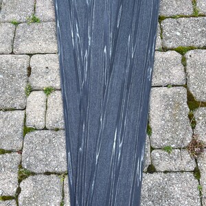 May include: Four black woodgrain strips with a white woodgrain pattern.