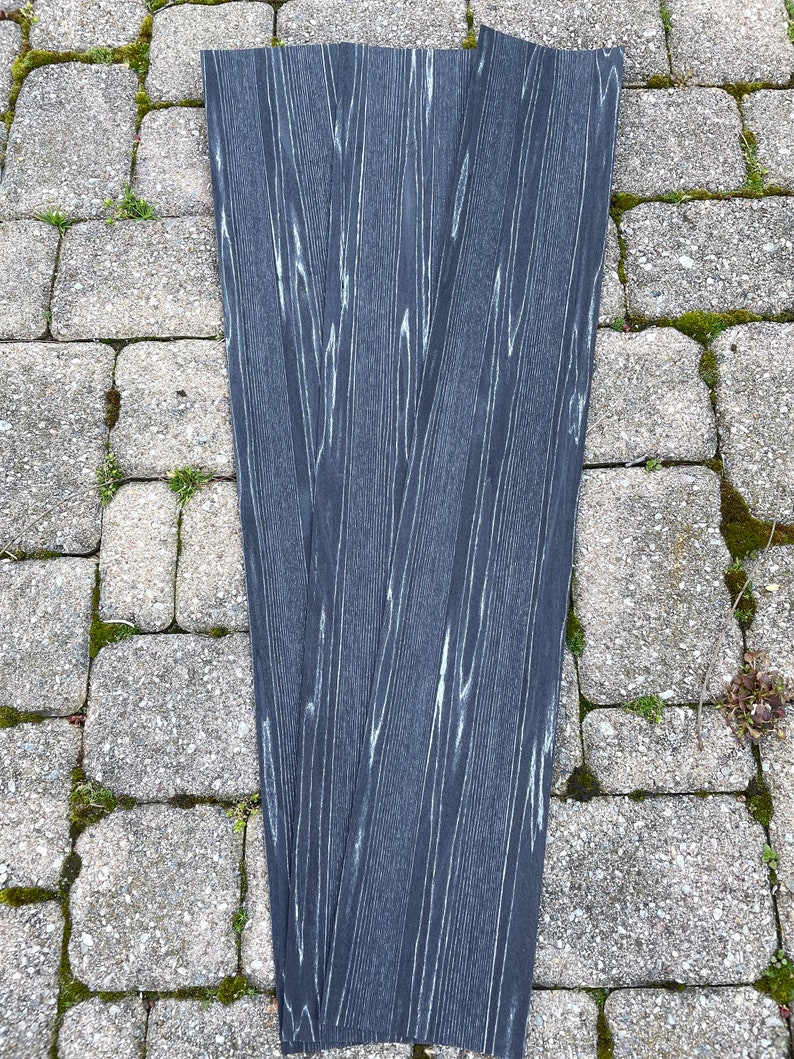 May include: Four black woodgrain strips with a white woodgrain pattern.
