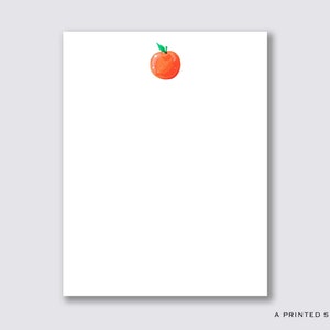 May include: A white notepad with a single orange peach illustration in the top centre.