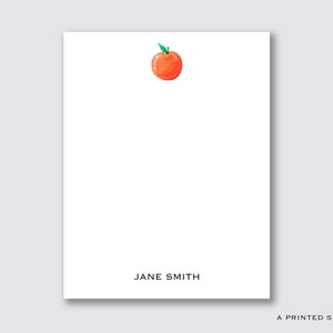 May include: A white card with a simple orange fruit illustration and the text "JANE SMITH" at the bottom.