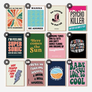 May include: Twelve colorful retro-style posters with various song lyrics and titles. The posters are framed in wood and have a white background.