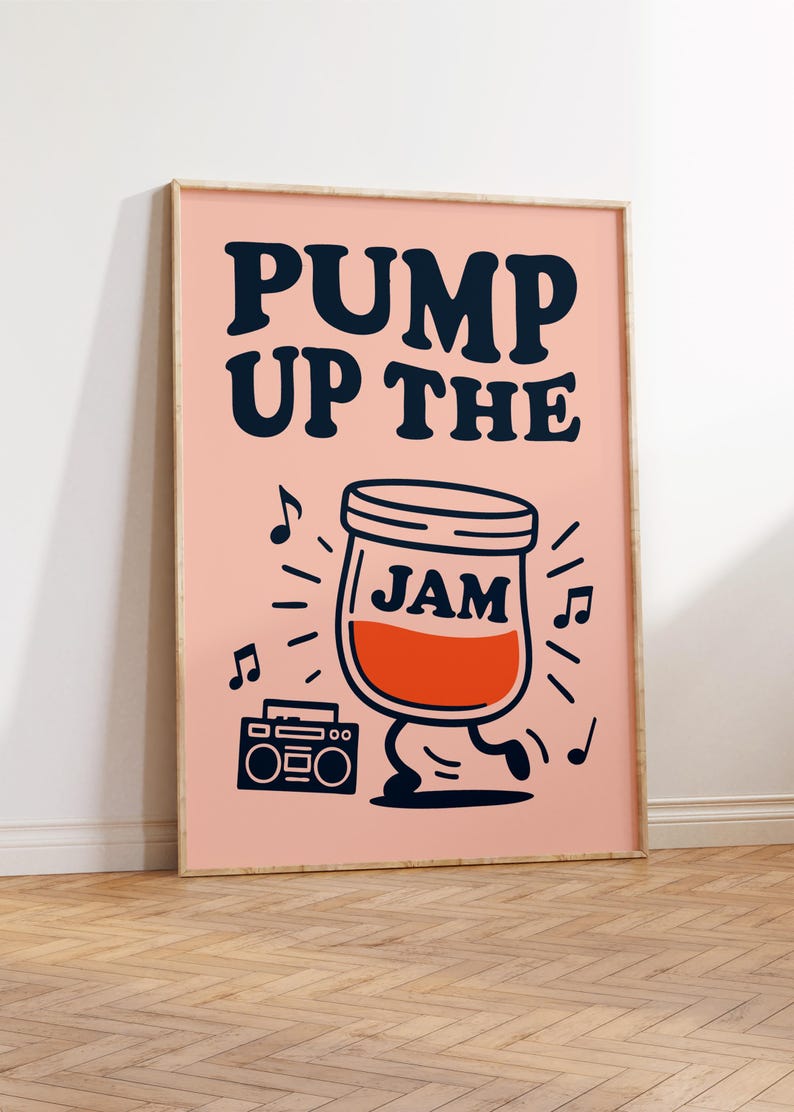 May include: A framed art print with a pink background and the words "PUMP UP THE JAM" in navy blue. A cartoon jar of jam with legs dances next to a boombox, surrounded by musical notes.