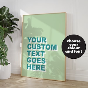 May include: A framed poster with a light green background and white shadowing. The text "YOUR CUSTOM TEXT GOES HERE" is in a teal blue color with a white outline. The text is in a bold, sans-serif font. A black circle with white text says "choose your colour and font".
