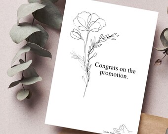May include: A white greeting card with a black line drawing of a flower and the text "Congrats on the promotion." The card also includes the text "Gotcha, bitch!" and a hand gesture.