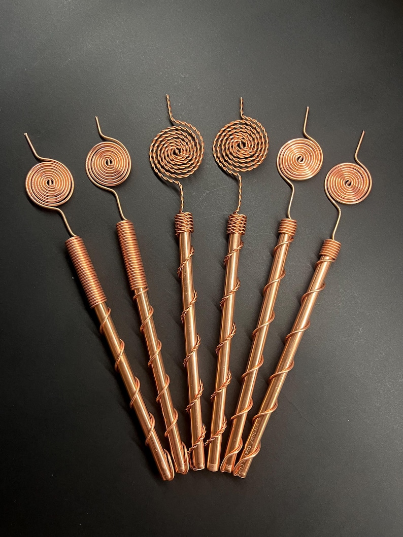 Set of six Tesla 369 copper spiral electroculture antennas displayed on dark background