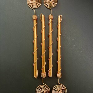 Macro shot of Tesla-inspired copper spiral antenna with visible tensor weave pattern highlighting fine handmade craftsmanship and conductive copper wire.