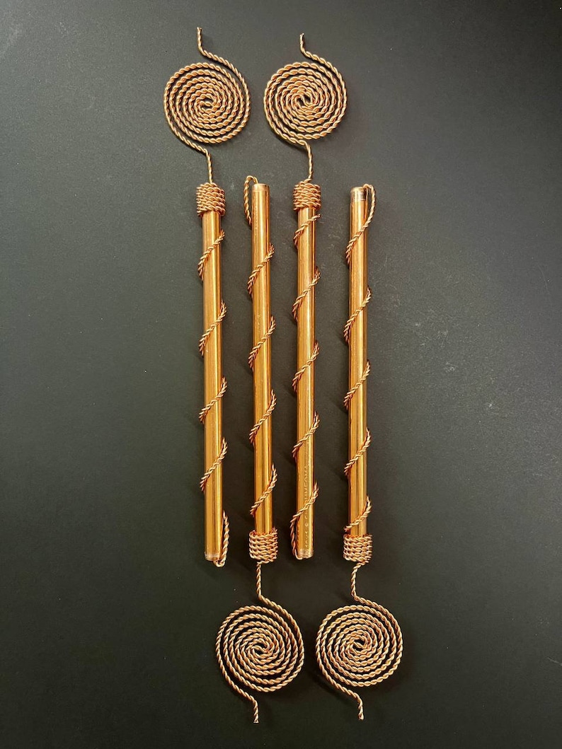 Macro shot of Tesla-inspired copper spiral antenna with visible tensor weave pattern highlighting fine handmade craftsmanship and conductive copper wire.