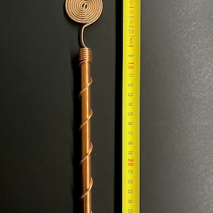 Copper antenna beside ruler showing 33 cm size for installation reference