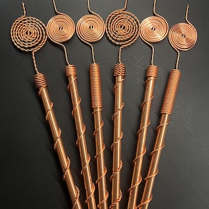 Assorted Tesla exotic mix copper antennas displayed in geometric layout for visual variety