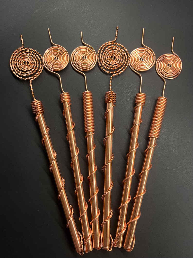 Assorted Tesla exotic mix copper antennas displayed in geometric layout for visual variety