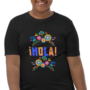 May include: Black youth t-shirt with a colorful floral design and the text "¡HOLA!" in blue and orange letters.