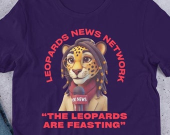 May include: Purple t-shirt with a cartoon leopard wearing a red scarf and holding a microphone. The text "LEOPARDS NEWS NETWORK" is in a circle around the leopard. The text "THE LEOPARDS ARE FEASTING" is below the leopard.