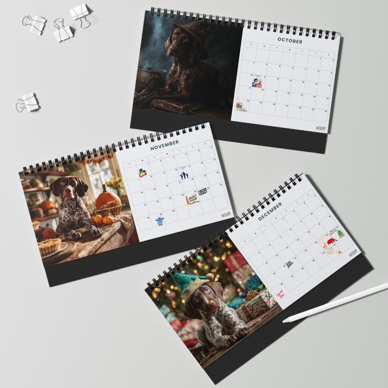 May include: Three spiral-bound desk calendars featuring photographs of a brown and white dog. The October page shows a dog in a witch hat, November features a dog with pumpkins, and December displays a dog in an elf hat. Each page includes a grid.