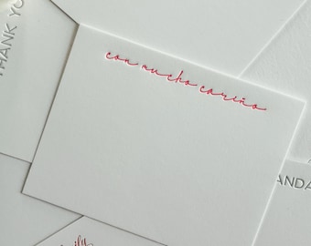 May include: A stack of white note cards with the text "The Lopez Family" and "con mucho cariño" printed in red. The top card has the text "& Alfredo" printed in gray.