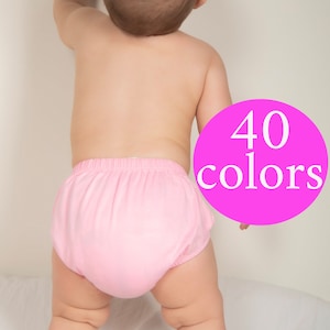 May include: A baby wearing a pink diaper cover. The image has a pink circle with the text "40 colors" on it.