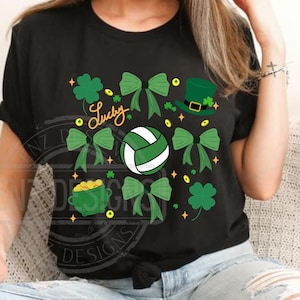 May include: Black t-shirt with a green volleyball, shamrocks, gold coins, and a leprechaun hat. The text "Lucky" is written in green on the shirt.