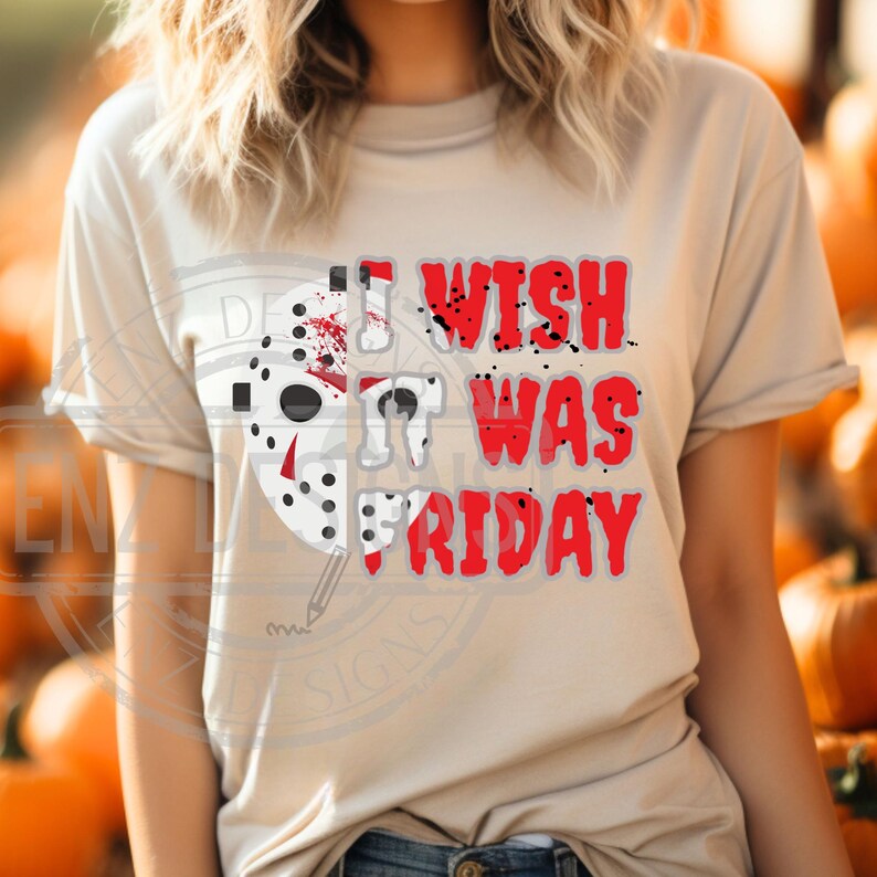 K&ouml;nnte beinhalten: Ein beiges T-Shirt mit einer roten und wei&szlig;en Grafik eines Hockey-Masks mit Blutspritzern und dem Text "I wish it was Friday".