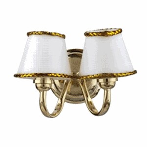 May include: A brass wall sconce with two white lampshades trimmed with gold rope. The sconce has a traditional design and would be a great addition to any home.