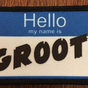 May include: A blue and white name tag with black text that reads "Hello my name is GROOT".