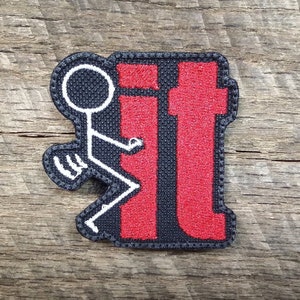 May include: A black and white stick figure giving the middle finger with the word "it" in red behind it. The image is a patch.