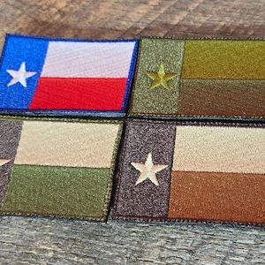May include: Four embroidered patches featuring the Texas state flag design. One patch has the traditional blue, white, and red colors. The other three patches have a similar design but use earth-tone colors like olive green, tan, and brown. Each patch has a white star.