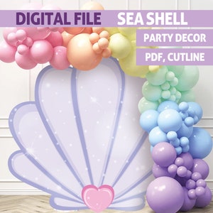 May include: A purple seashell backdrop with a pink heart at the bottom. The backdrop is decorated with a rainbow of balloons in pastel colours. The text "SEA SHELL PARTY DECOR PDF, CUTLINE" is at the top of the image.