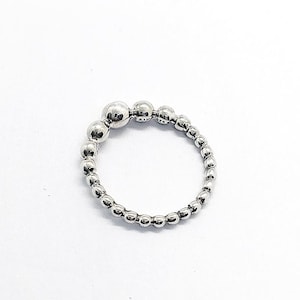 May include: A polished sterling silver ring composed of a continuous band of small, uniform spherical beads. The ring features a slightly larger bead at the top center, with the hallmark ALE 925 engraved on the side of the band near the top.