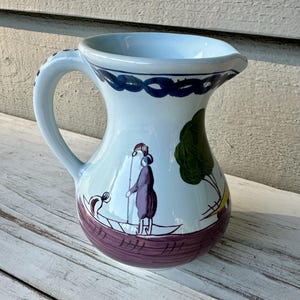 May include: A white ceramic mug with a black handle and the text "But First, Coffee" in a bold, black font. The mug is likely 11-15 ounces, perfect for a morning beverage. The design is simple and modern.