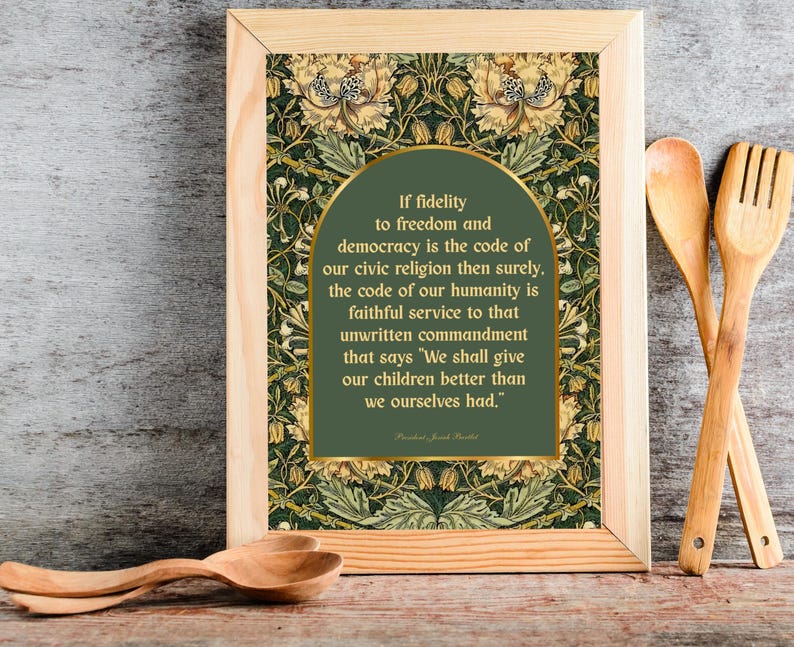 May include: Wooden framed print with a green and gold floral pattern background. The print features a quote in a green arch shape with gold trim. Wooden spoons and a spatula are next to the framed print.