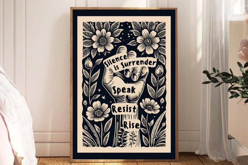 May include: Black and white illustration of a raised fist with flowers and leaves surrounding it. The fist is holding a banner that reads "Silence is Surrender". Below the fist are the words "Speak Resist Rise".
