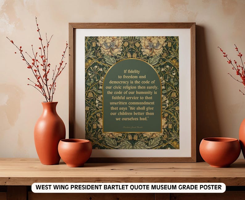 May include: A framed museum-grade poster featuring a quote by President Bartlet from The West Wing. The quote is set against a green and gold floral background. The frame is a warm brown, and the poster is displayed with terracotta vases and branches.