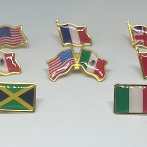 May include: A collection of flag pins, including the United States, France, United Kingdom, Mexico, Canada, Jamaica, and Italy. Each pin features a gold border and a colorful enamel design of the respective national flag.