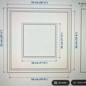 May include: Diagram of a square frame with dimensions in inches and centimeters. The outer frame measures 20 1/2 inches (52 cm) square, with an inner square of 11 3/4 inches (30 cm). The frame is 2 1/4 inches (6 cm) thick.
