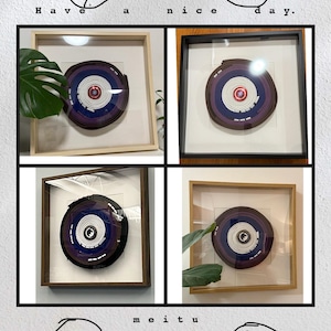 May include: Four framed circular art pieces with concentric rings of color, including blue, purple, and white. Each piece is encased in a different style frame, with a light wood, dark wood, and black frame. The text "Have a nice day" is at the top.